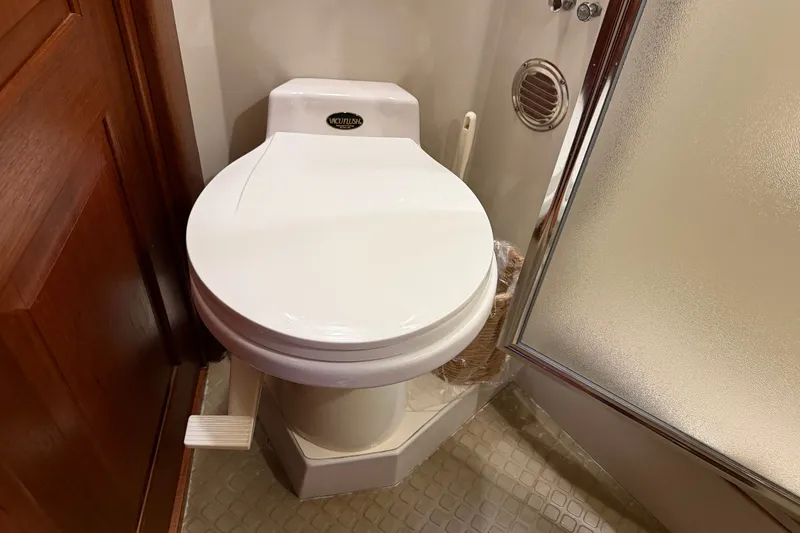 Slide: The Image of 1989 Californian Aft Cabin bathroom with white toilet and shower. - 43