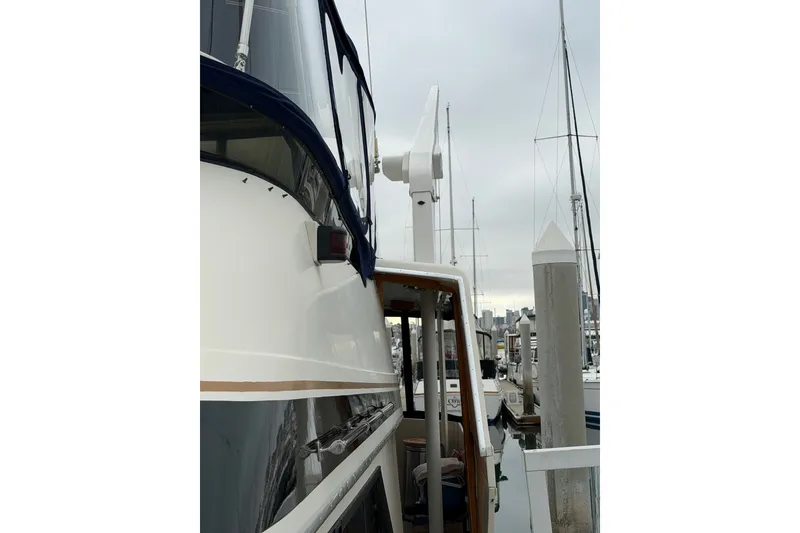 Slide: The Image of 1989 Californian Aft Cabin yacht docked at marina, side view with overcast sky. - 50