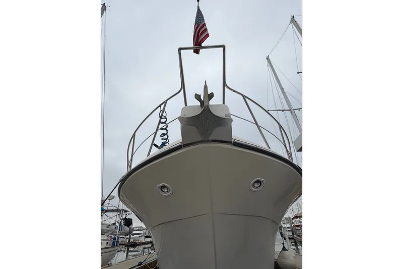 Slide: The Image of 1989 Californian Aft Cabin yacht with American flag, docked in marina. - 56