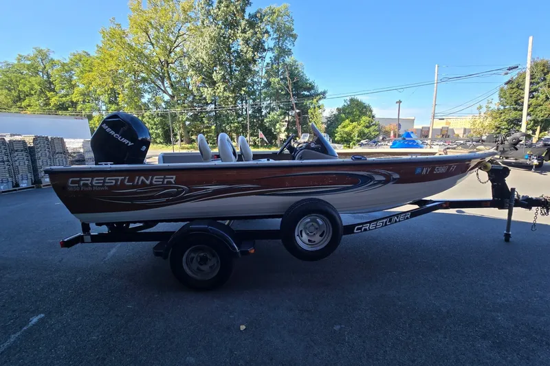 Slide: The Image of 2008 Crestliner 1850 Fish Hawk SC boat on trailer, parked outdoors. - 6