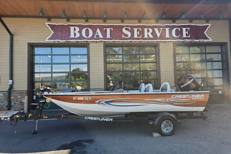 Slide: The Image of 2008 Crestliner 1850 Fish Hawk SC boat at service center, parked on trailer. - 9