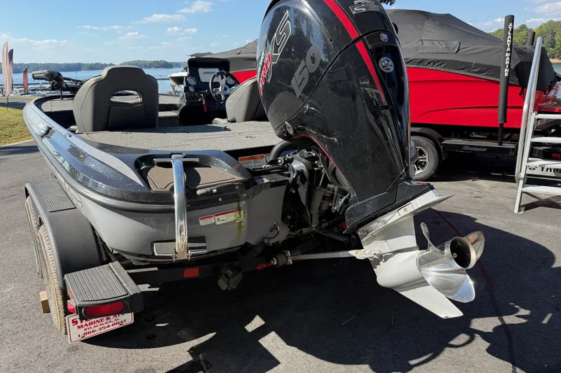 Slide: The Image of 2024 Nitro Z18 boat with powerful outboard motor, parked near a scenic lake. - 7