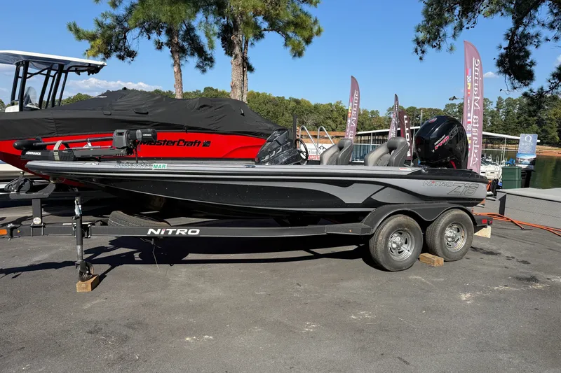 Slide: The Image of 2024 Nitro Z18 boat on trailer, parked outdoors near marina. - 1
