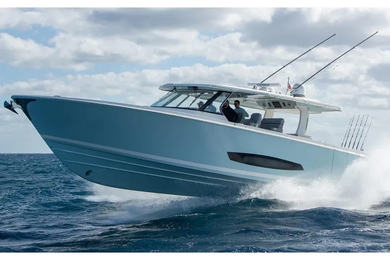 Slide: The Image of Manufacturer Provided Image: 2026 Regal 50 SAV boat cruising on open water under a cloudy sky. - 2