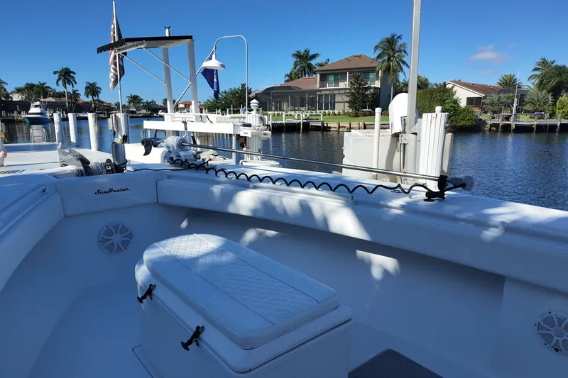 Slide: The Image of 2017 SeaHunter 41 Tournament boat docked by waterfront homes, under clear blue sky. - 18