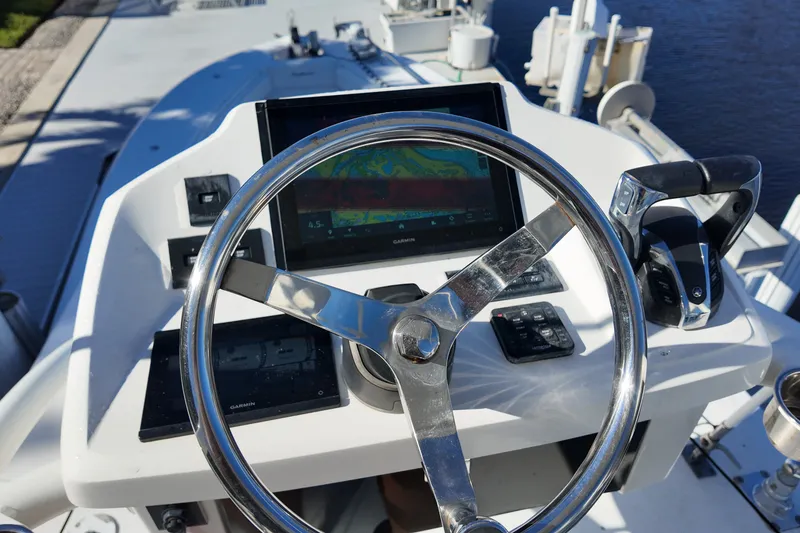 Slide: The Image of Steering console of 2017 SeaHunter 41 Tournament boat with navigation display and controls. - 24