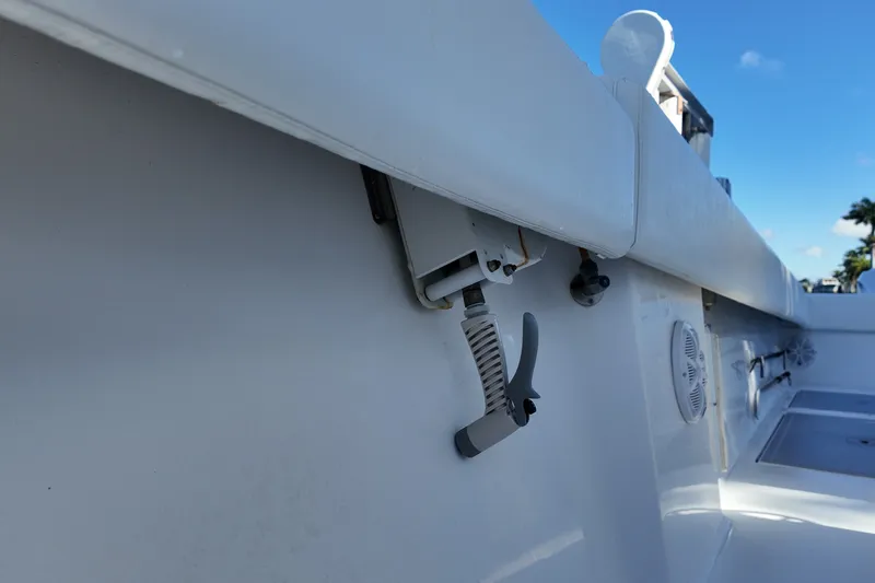 Slide: The Image of 2017 SeaHunter 41 Tournament boat interior detail with lever and speaker, under clear blue sky. - 32