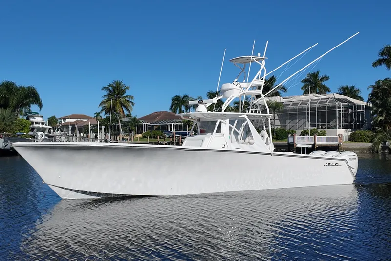 The Image of 2017 SeaHunter 41 Tournament boat on calm water, surrounded by palm trees and clear blue sky. - 1
