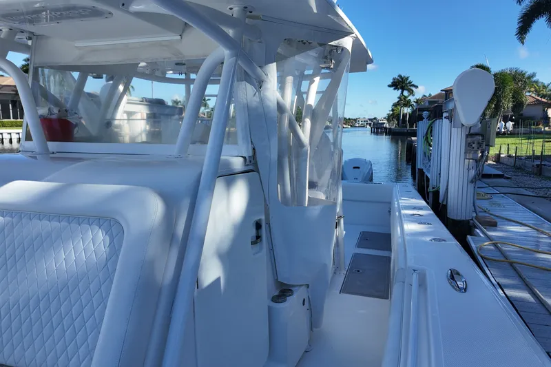 Slide: The Image of 2017 SeaHunter 41 Tournament boat docked by a scenic waterfront. - 23
