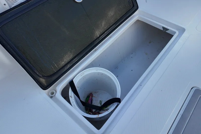 Slide: The Image of Open storage compartment on 2017 SeaHunter 41 Tournament boat with bucket inside. - 33