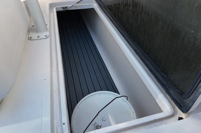 Slide: The Image of Storage compartment on a 2017 SeaHunter 41 Tournament boat with a white bucket inside. - 29