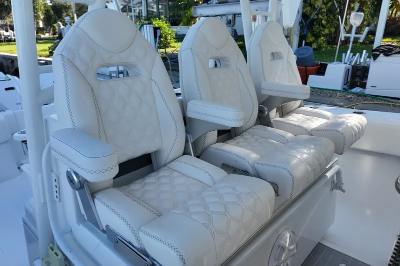 Slide: The Image of Luxurious seating on a 2017 SeaHunter 41 Tournament boat, featuring quilted white upholstery. - 15