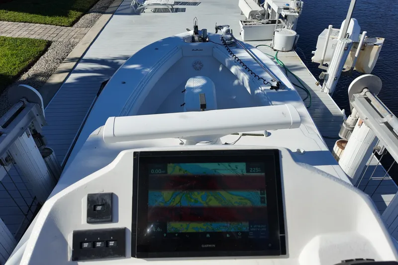 Slide: The Image of 2017 SeaHunter 41 Tournament boat with navigation display, docked on a sunny day. - 22
