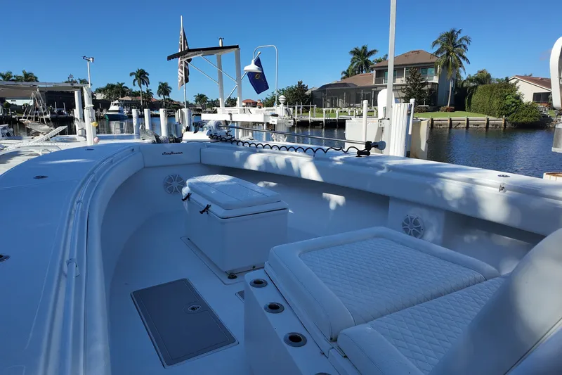 Slide: The Image of 2017 SeaHunter 41 Tournament boat docked in a sunny marina with palm trees. - 19