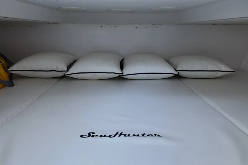 Slide: The Image of Interior cabin of 2017 SeaHunter 41 Tournament boat with white cushions and logo. - 26