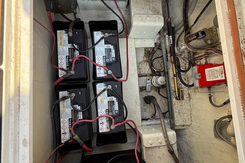 Slide: The Image of Battery compartment of a 1979 Bertram 35 Flybridge boat with wiring and components. - 49