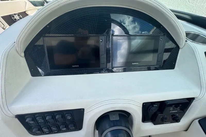 Slide: The Image of Dashboard of a 2021 Regal 29 OBX boat featuring dual Garmin displays. - 9