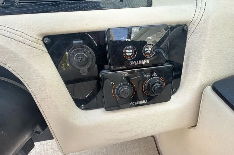 Slide: The Image of Control panel of a 2021 Regal 29 OBX boat featuring Yamaha start-stop buttons. - 11