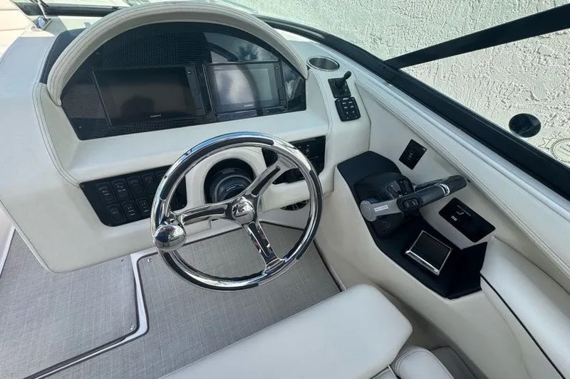Slide: The Image of 2021 Regal 29 OBX boat cockpit with modern steering and control panel. - 8