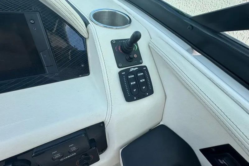 Slide: The Image of Control panel of a 2021 Regal 29 OBX boat with joystick and switches. - 10
