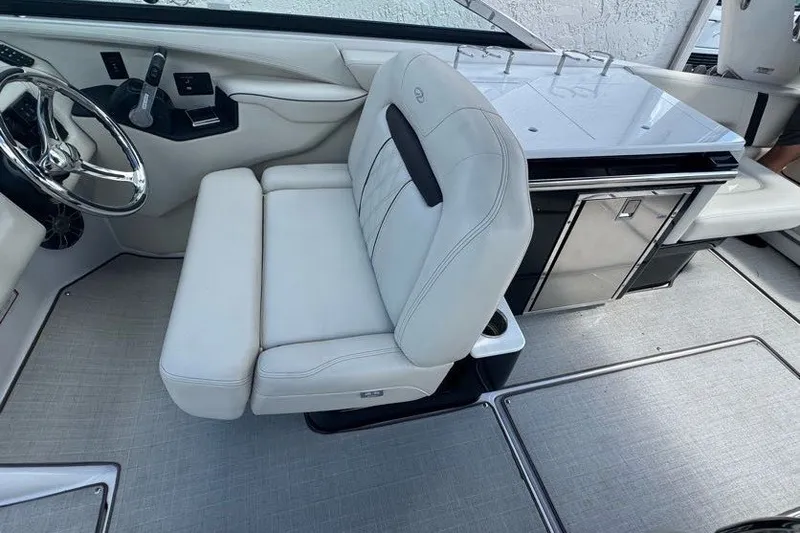 Slide: The Image of 2021 Regal 29 OBX boat interior with white captain's seat and sleek dashboard. - 7