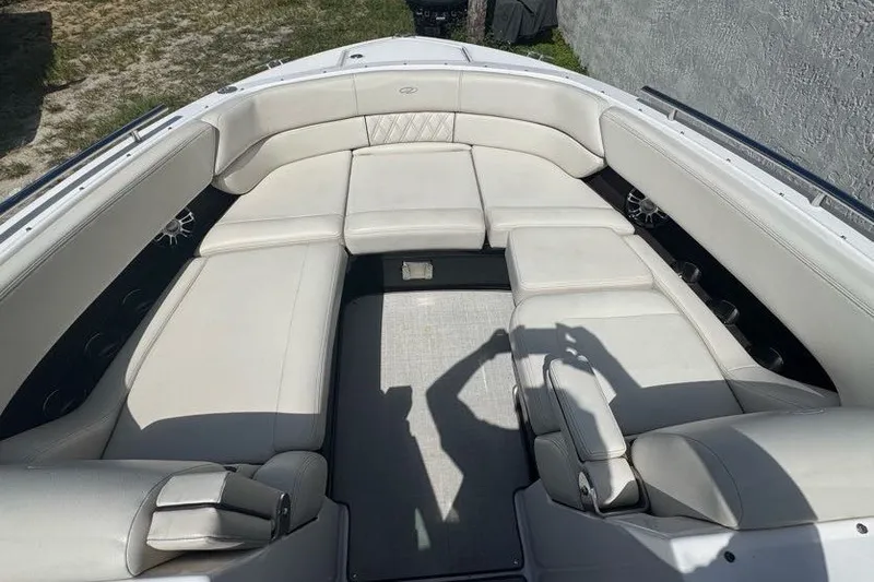 Slide: The Image of 2021 Regal 29 OBX boat interior with spacious white seating and modern design. - 5