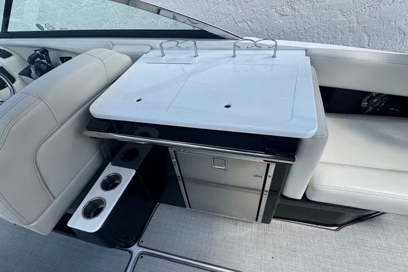 Slide: The Image of Interior of 2021 Regal 29 OBX boat featuring seating and a compact kitchenette. - 20