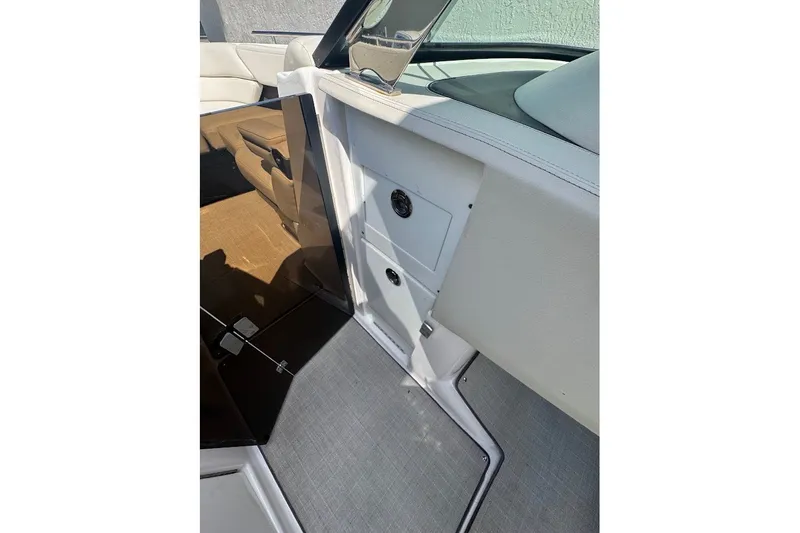 Slide: The Image of 2021 Regal 29 OBX boat interior with sleek white and beige seating and modern design. - 26
