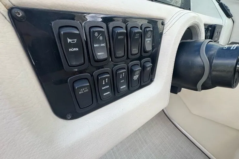 Slide: The Image of Control panel of a 2021 Regal 29 OBX boat with various switches. - 12