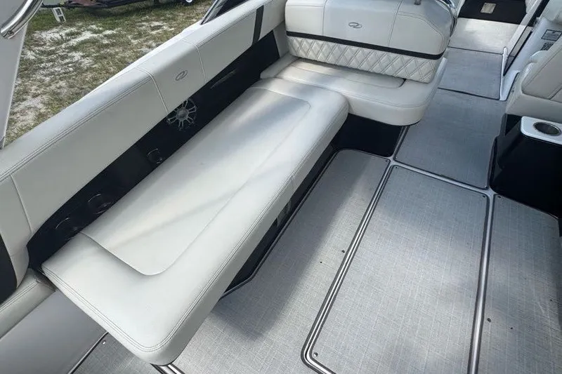 Slide: The Image of 2021 Regal 29 OBX boat interior with white seating and modern flooring. - 21