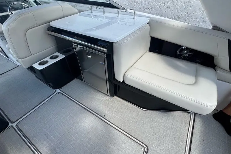 Slide: The Image of Luxurious interior of 2021 Regal 29 OBX boat with white seating and mini fridge. - 18