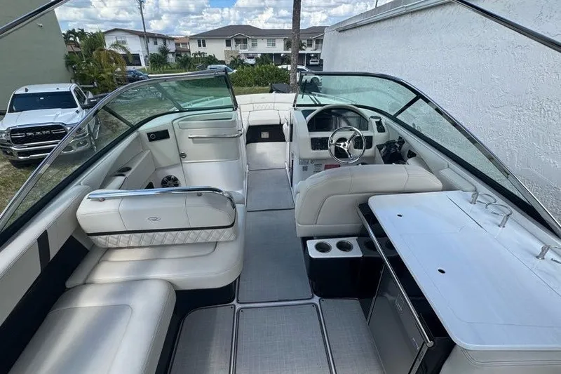 Slide: The Image of 2021 Regal 29 OBX boat interior with luxurious seating and modern dashboard. - 14