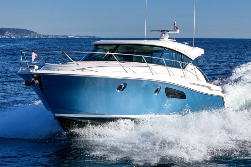 Slide: The Image of 2021 Tiara C 44 Coup yacht cruising on open water, showcasing sleek design and performance. - 62