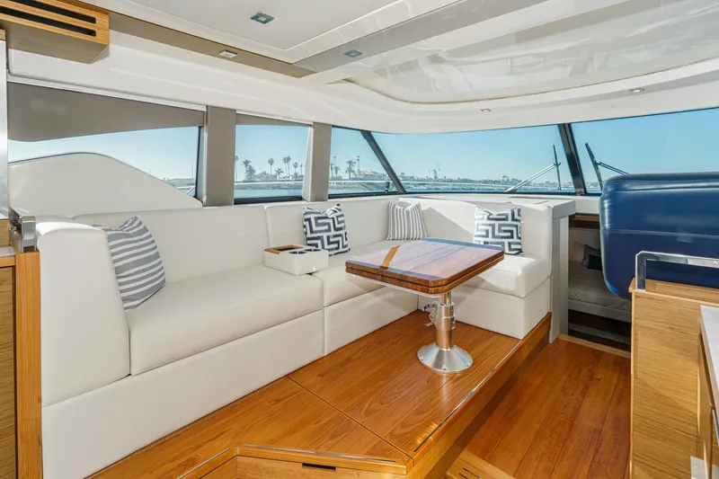 Slide: The Image of Luxurious interior of 2021 Tiara C 44 Coup yacht with elegant seating and wooden table. - 13