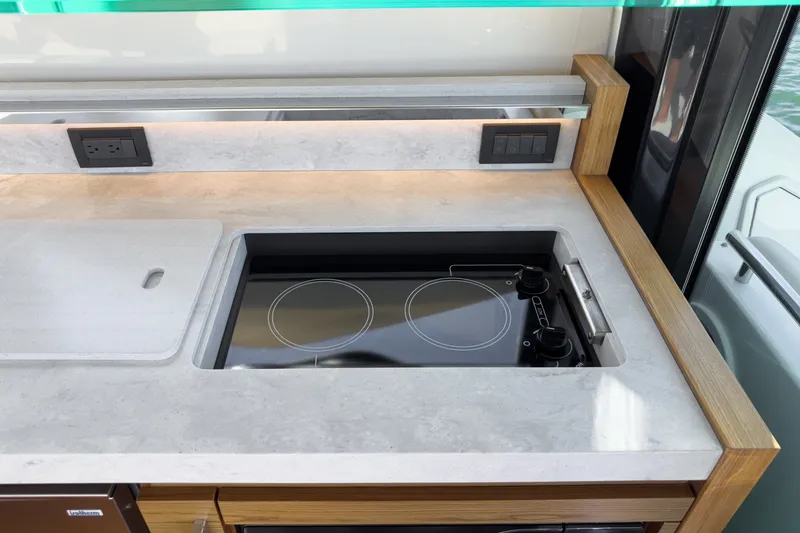 Slide: The Image of Modern kitchen area in 2021 Tiara C 44 Coup yacht with sleek stovetop. - 21