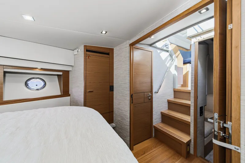 Slide: The Image of Interior of 2021 Tiara C 44 Coup yacht, featuring wooden stairs and modern design. - 32