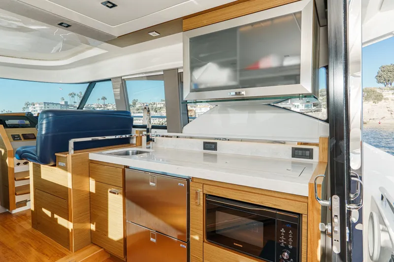 Slide: The Image of Luxurious interior of 2021 Tiara C 44 Coup yacht with modern kitchen amenities. - 4