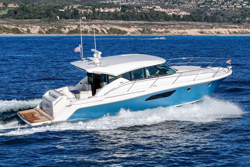 The Image of 2021 Tiara C 44 Coup yacht cruising on blue ocean waters. - 0