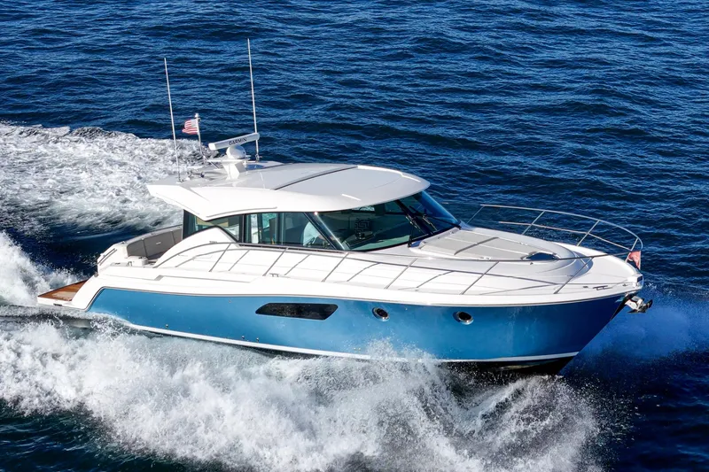 Slide: The Image of 2021 Tiara C 44 Coup yacht cruising on open water. - 52