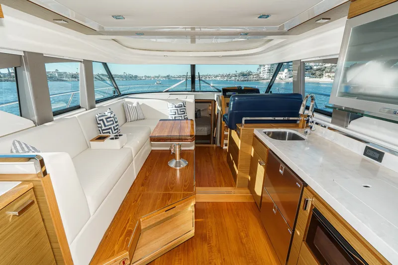 Slide: The Image of Luxurious interior of 2021 Tiara C 44 Coup yacht with modern kitchen and seating area. - 11