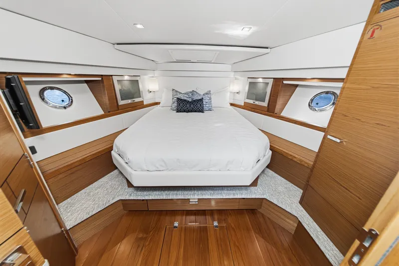 Slide: The Image of Luxurious 2021 Tiara C 44 Coup yacht bedroom with elegant wood finishes and modern design. - 31
