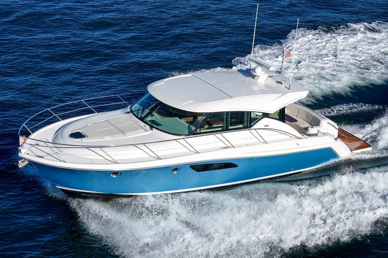 Slide: The Image of 2021 Tiara C 44 Coup yacht cruising on open water, showcasing sleek design and performance. - 66