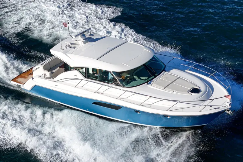 Slide: The Image of 2021 Tiara C 44 Coup yacht cruising on open water, showcasing sleek design and performance. - 51
