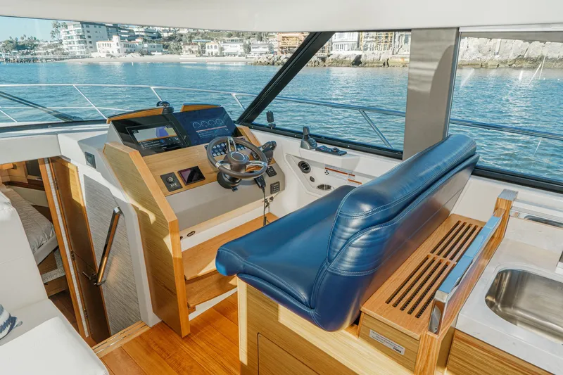 Slide: The Image of Interior of 2021 Tiara C 44 Coup yacht with helm and blue seating. - 23