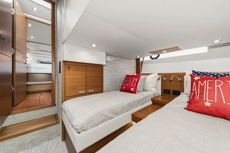 Slide: The Image of 2021 Tiara C 44 Coup interior cabin with twin beds and decorative pillows. - 43