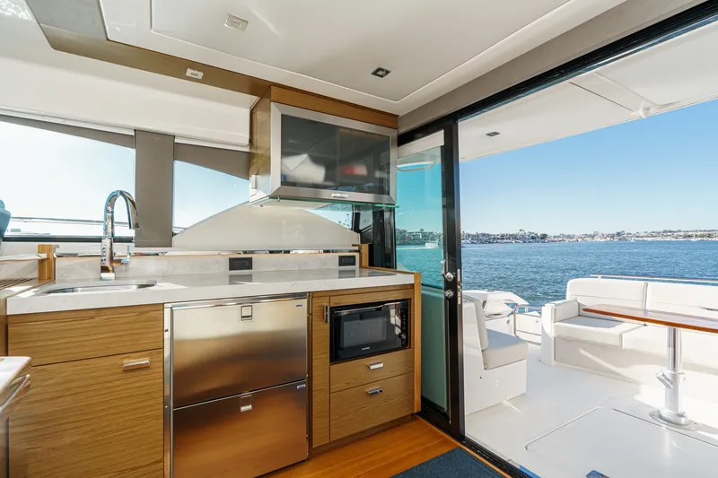 Slide: The Image of Interior of 2021 Tiara C 44 Coup yacht with modern kitchen and ocean view. - 16