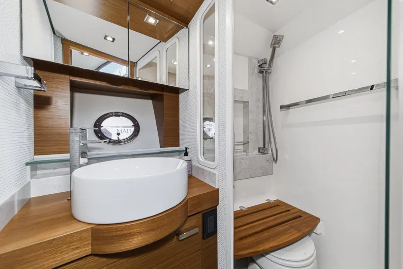 Slide: The Image of Luxurious 2021 Tiara C 44 Coup yacht bathroom with modern fixtures and wooden accents. - 37