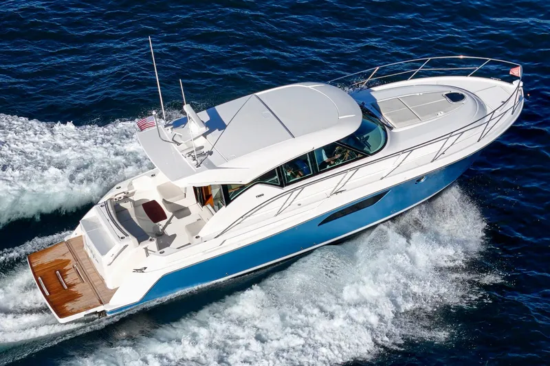 Slide: The Image of 2021 Tiara C 44 Coup yacht cruising on open water, aerial view. - 56