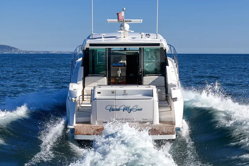 Slide: The Image of 2021 Tiara C 44 Coup yacht cruising on open sea with American flag. - 57