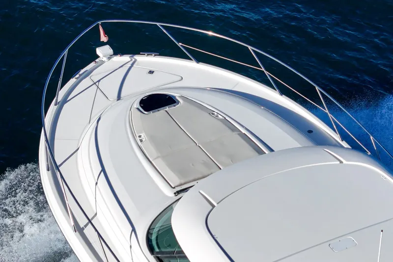 Slide: The Image of 2021 Tiara C 44 Coup yacht cruising on open water, top deck view. - 10